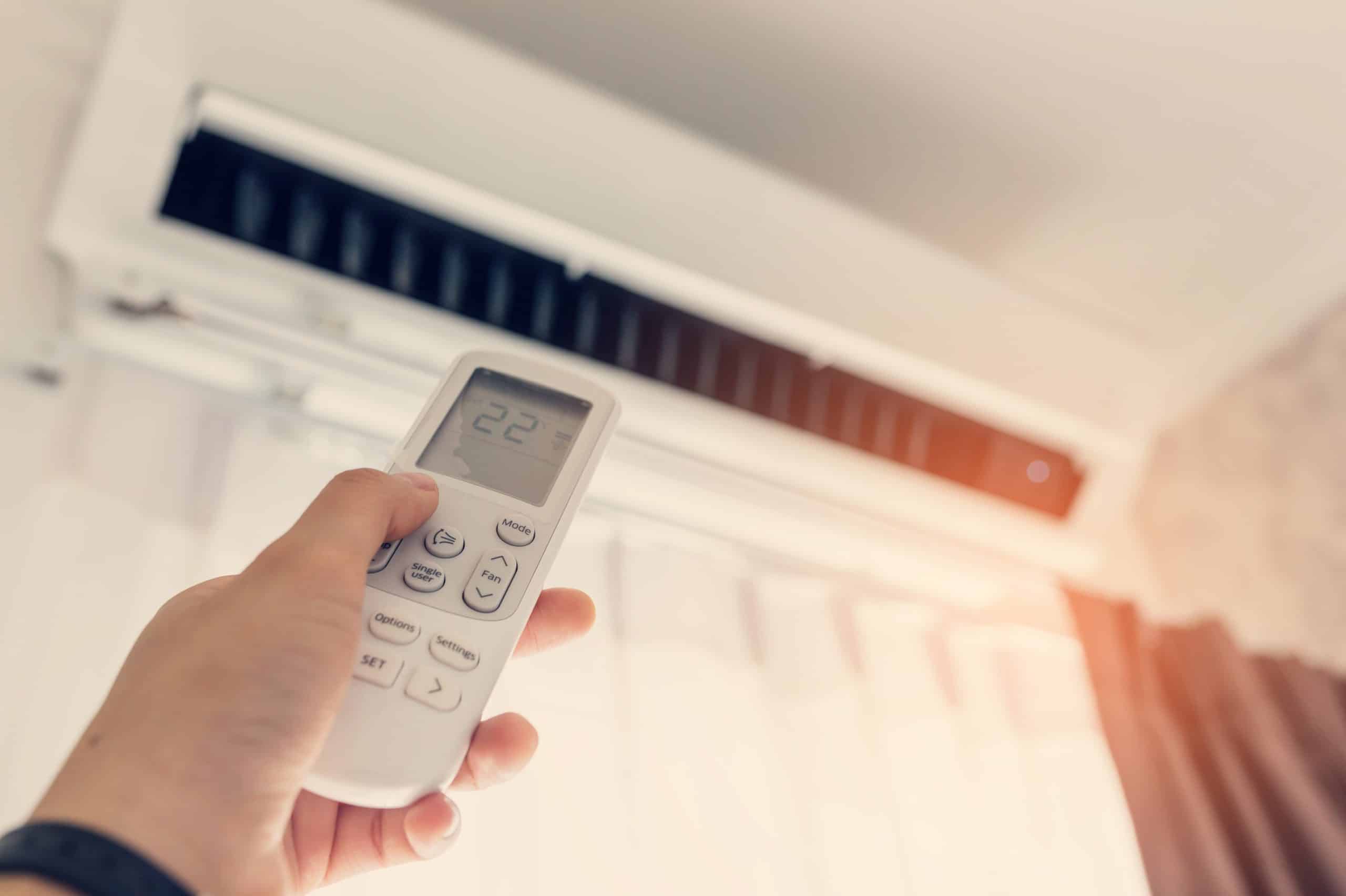Graphic illustrating the NSW Energy Saving Scheme by Efficient Energy Group. A modern air-conditioner unit is prominently displayed, with downward arrows symbolizing discounts. A backdrop of a happy family in a comfortable home highlights the benefits of the rebate program, emphasizing the combined efforts for a sustainable future