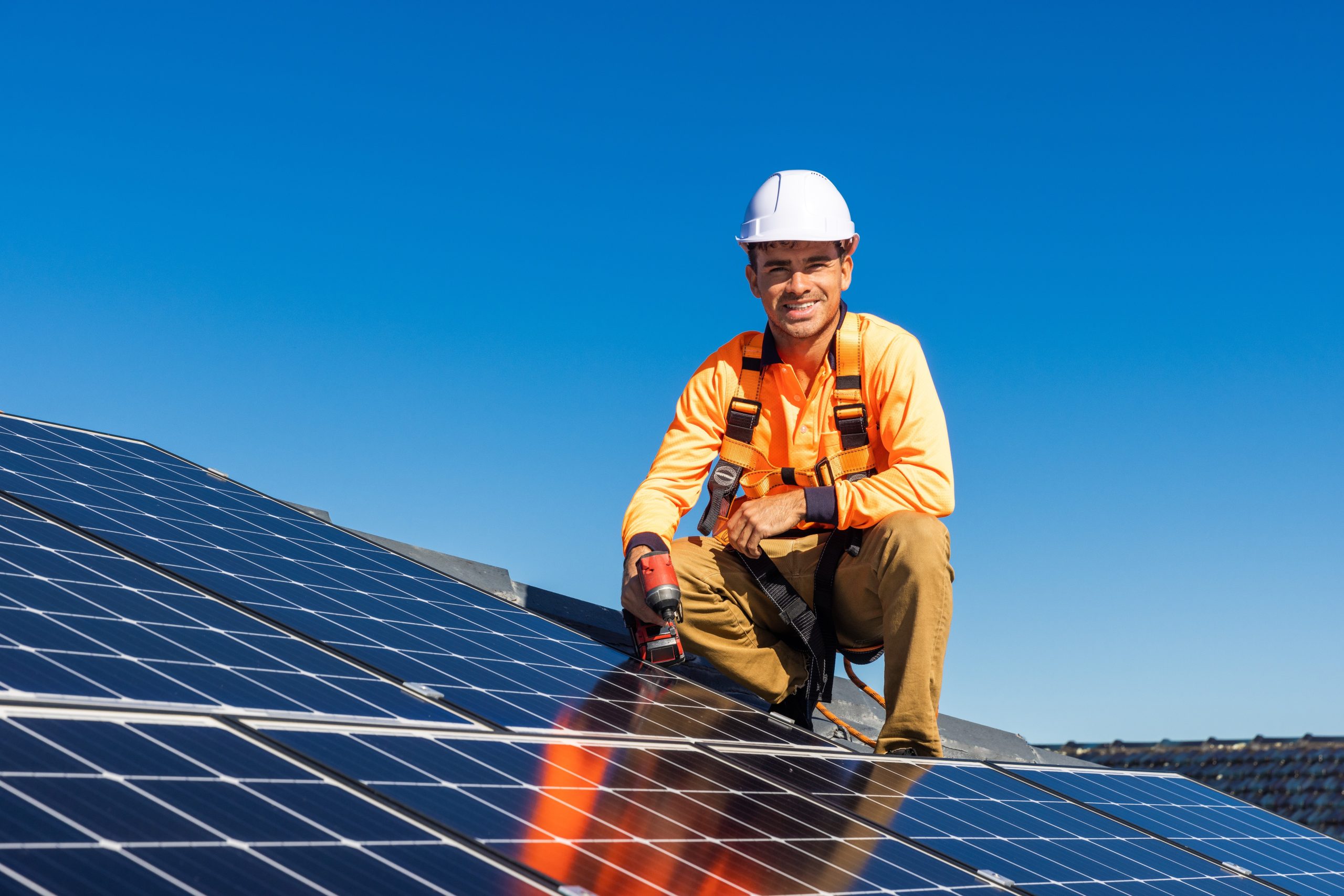 Photo of one of Efficient Energy Group's employees next to a newly installed Trina 440W solar panel installation in Milperra, Sydney.