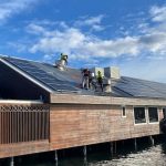 roof repairs in Sydney with trades working next to solar panels